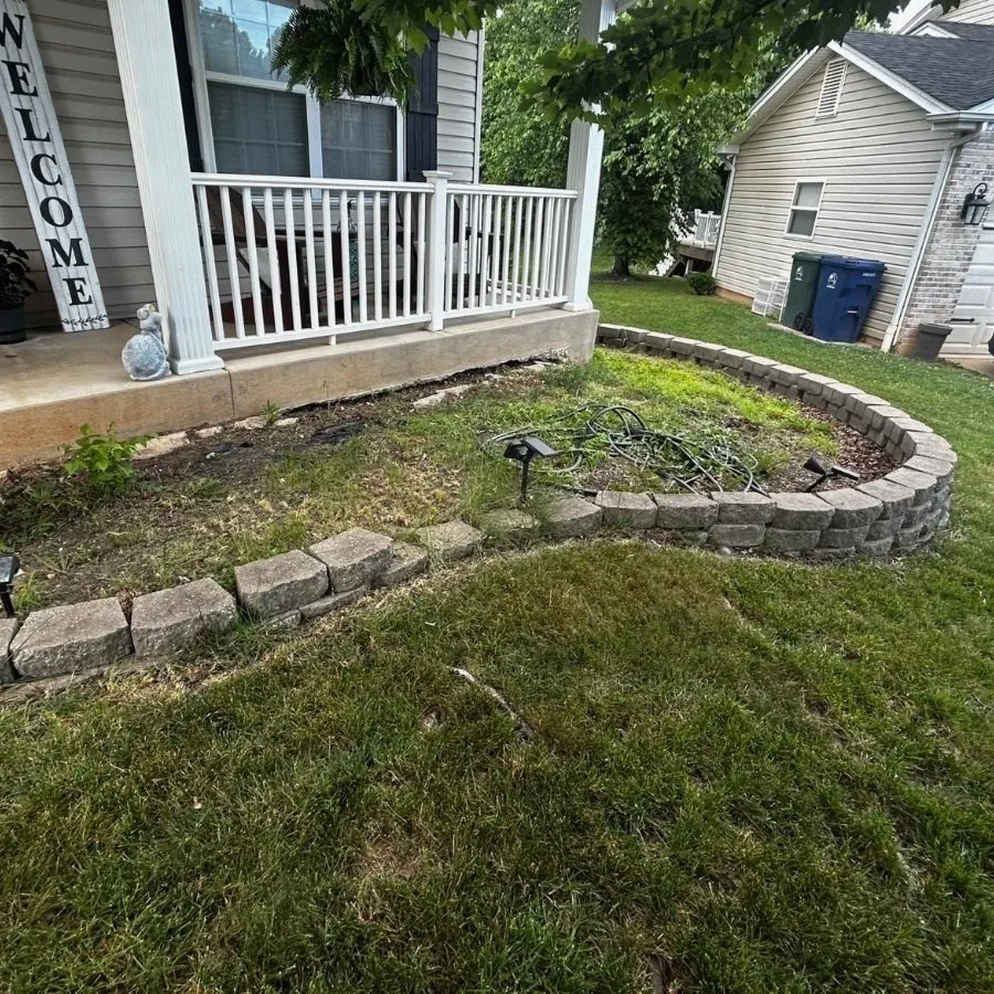 Weedy front bed with a loose block border before work, St. Charles